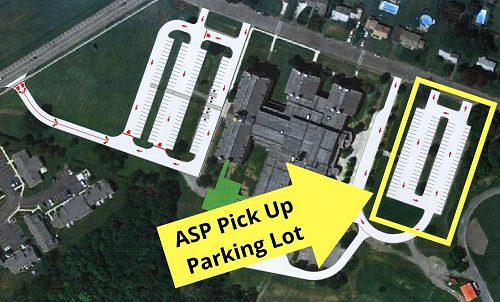 arrow and box showing where to park in the back upper parking lot