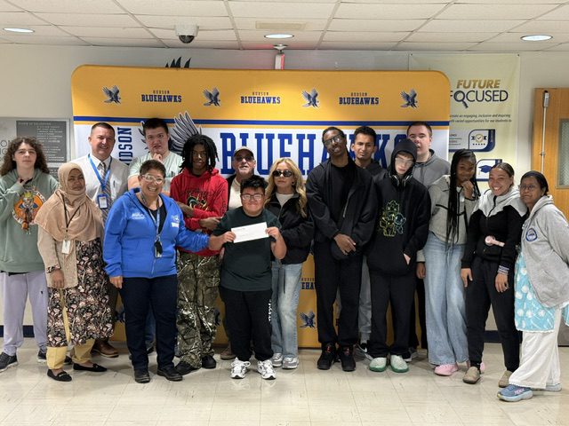 Kindness CLub students smile for photo with donation check from Abatecola foundation. 